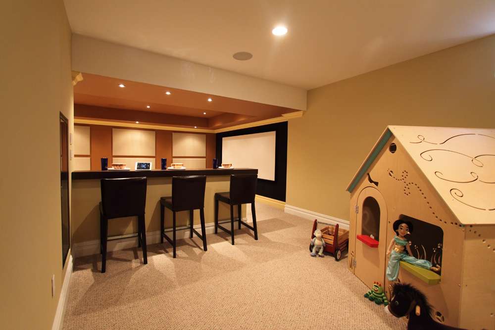 Basement family room with a bar and a movie screen