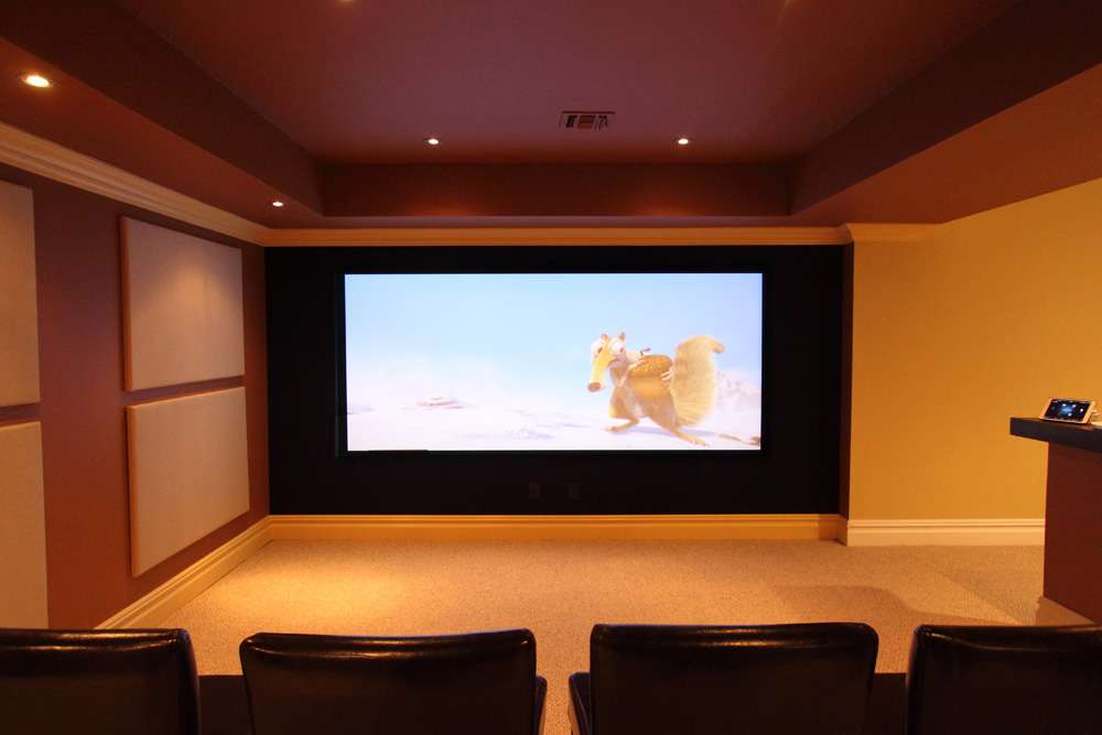 Media room with a wide screen and theater seats