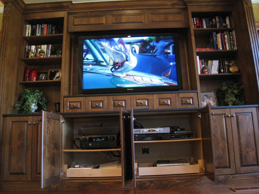 A large TV built into a dark wood wall unit in a New Jersey family room.