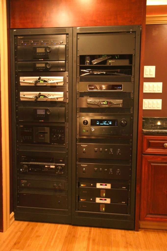 Home theater equipment neatly stacked in a built-in wall cabinet.