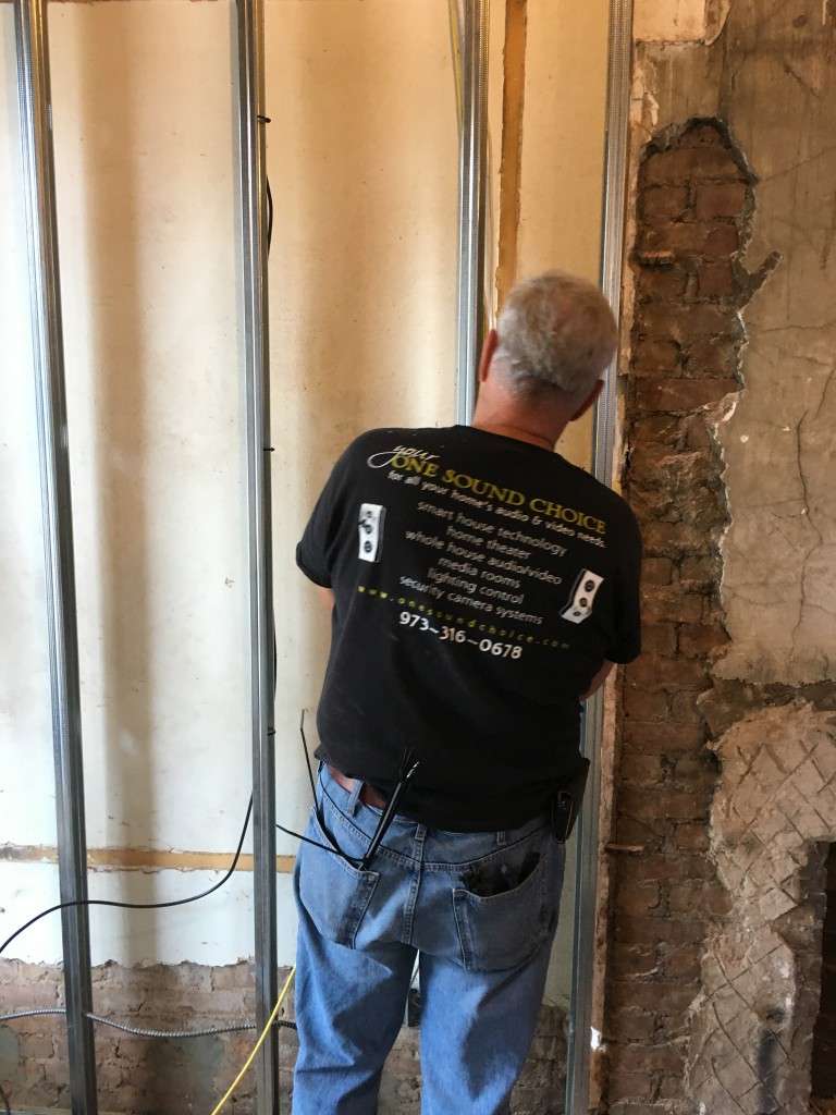 Technician from One Sound Choice working on a smart home integration project in Northern New Jersey