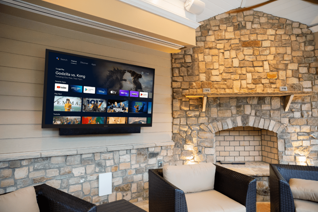 Outdoor entertainment system with weatherproof TV and landscape speakers
