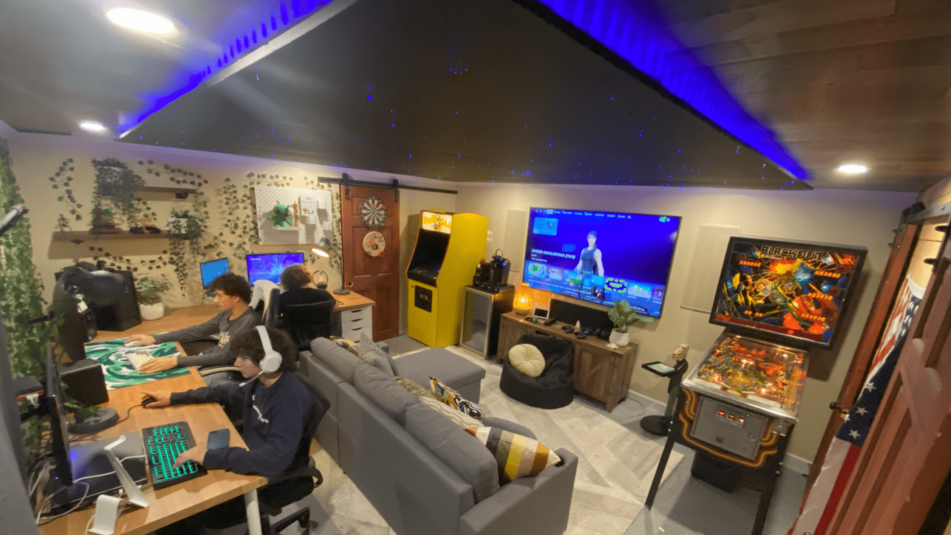 Custom gaming room featuring classic arcade games including Pac-Man-style cabinets and pinball