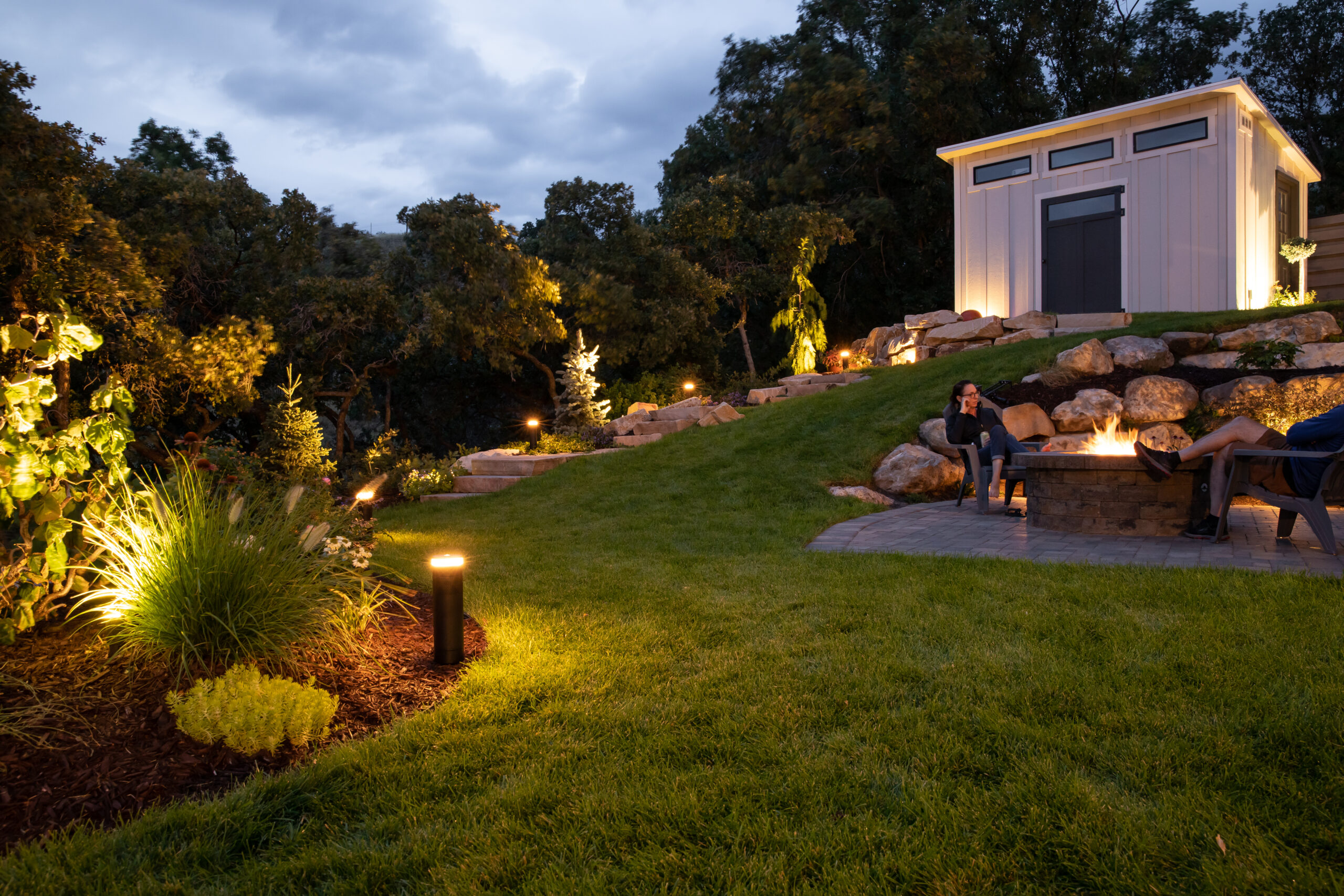 FX Radiance layered backyard at dusk with path, step, and soft architectural outdoor lighting