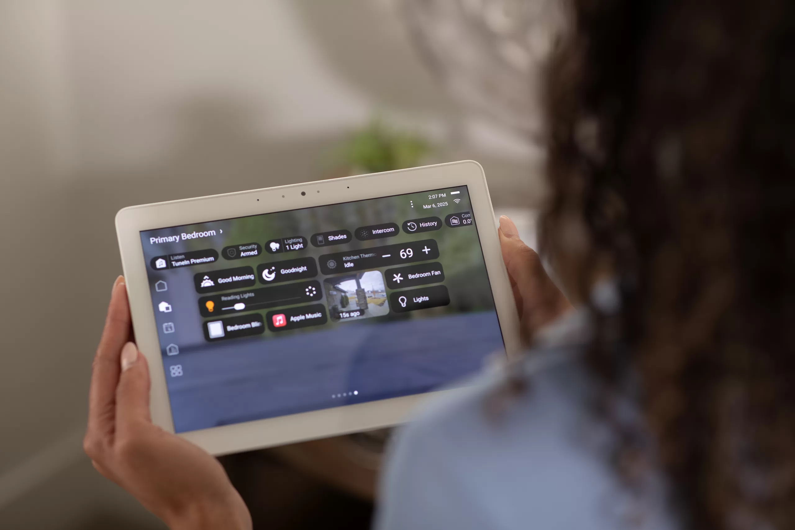 Bergen County mother monitoring her Bergen County smart home system on a smartphone to know when kids arrive home