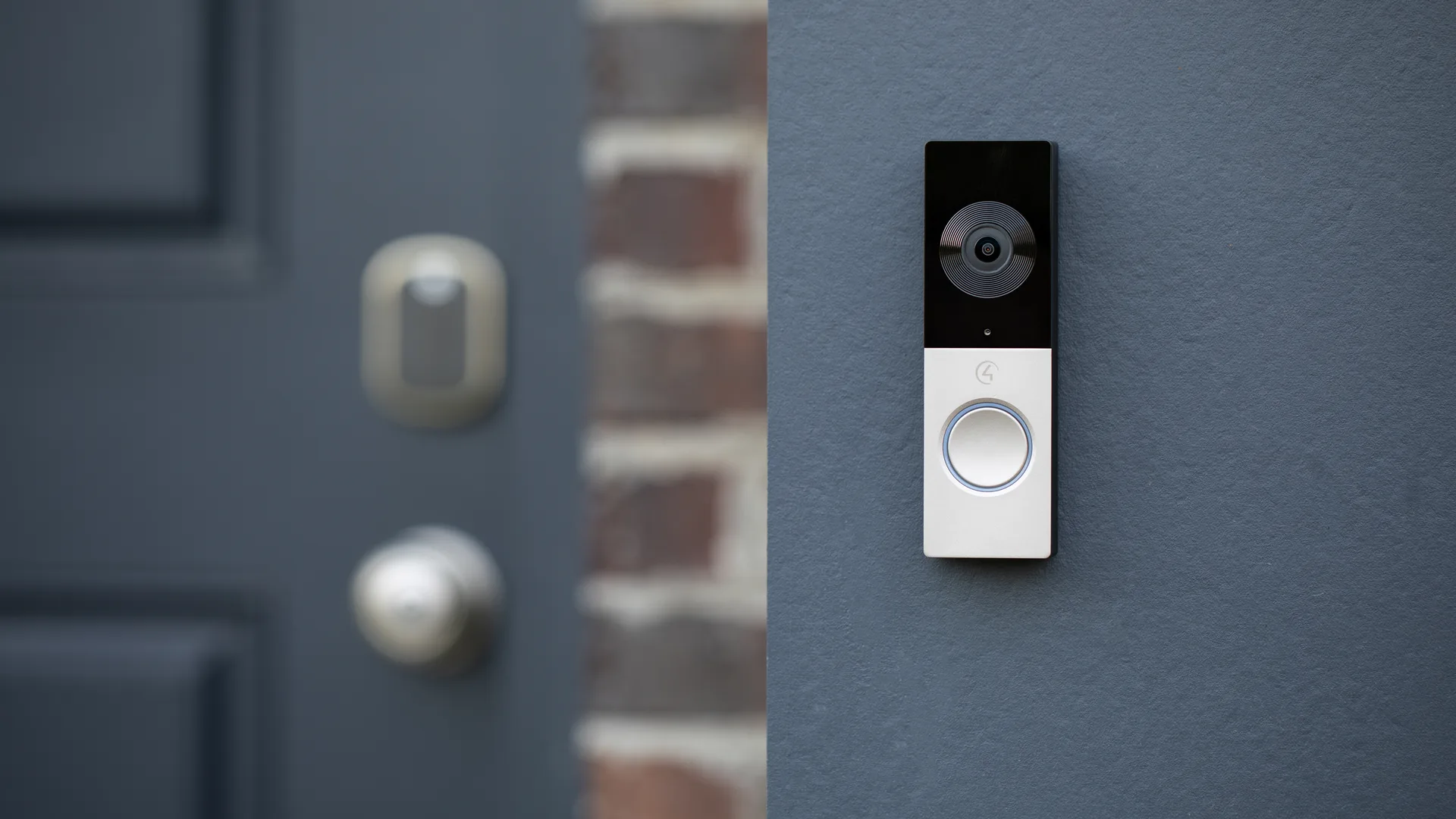Video doorbell on a gray wall beside a front door in a Northern New Jersey home
