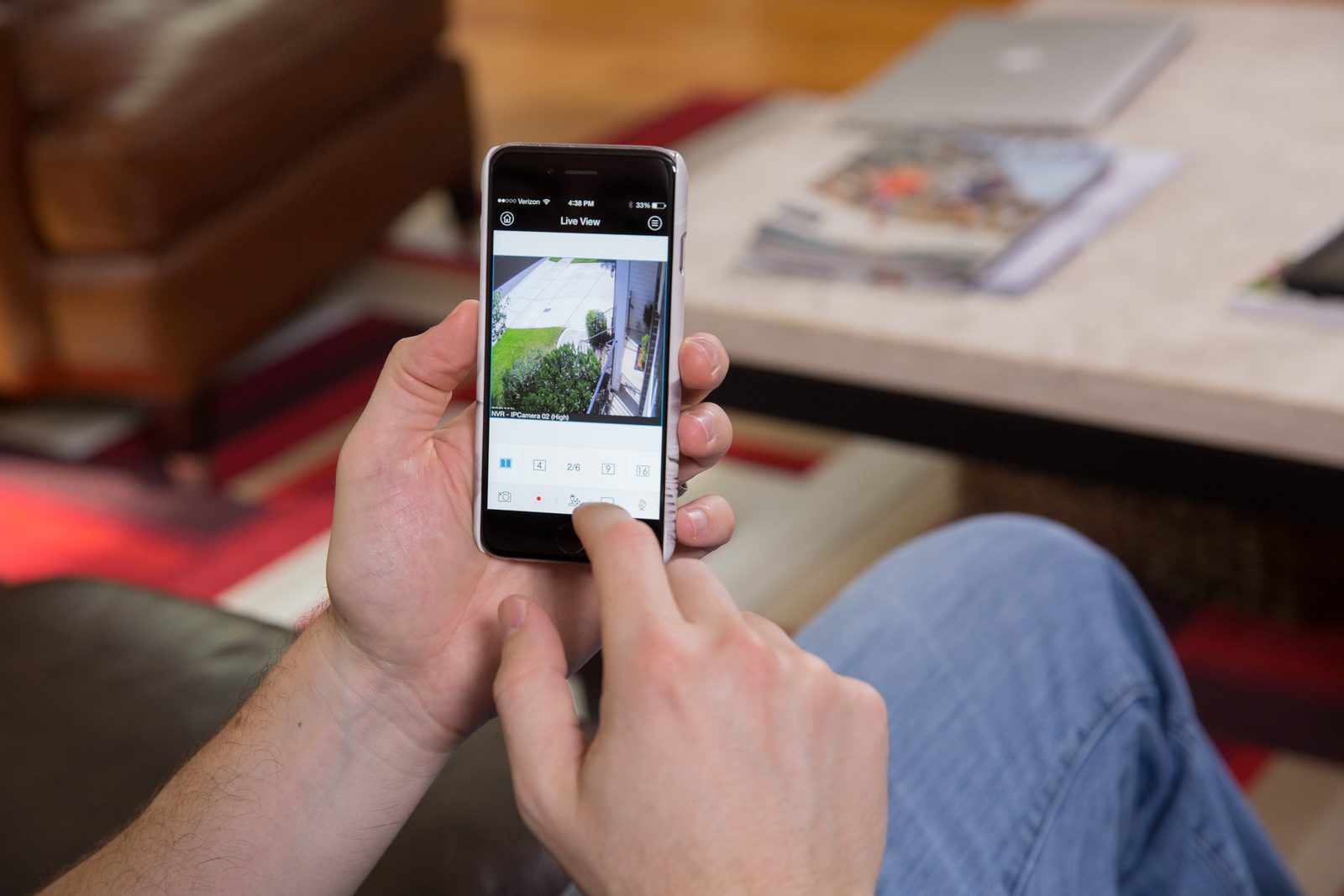 Homeowner checking live camera view on a phone app at home in Northern New Jersey